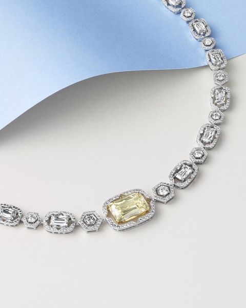 Boodles Mosaic necklace of white and yellow diamonds against pale blue and grey
